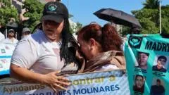 Residents dressed in white carried photos of missing relatives and signs reading 'We don't want fear, we want peace' as the protest marked the second anniversary of the conflict between Los Chapitos and La Mayiza.